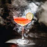 Alcoholic cocktail Greyhound, with vodka, liqueur, grapefruit juice and ice, black background, selective focus