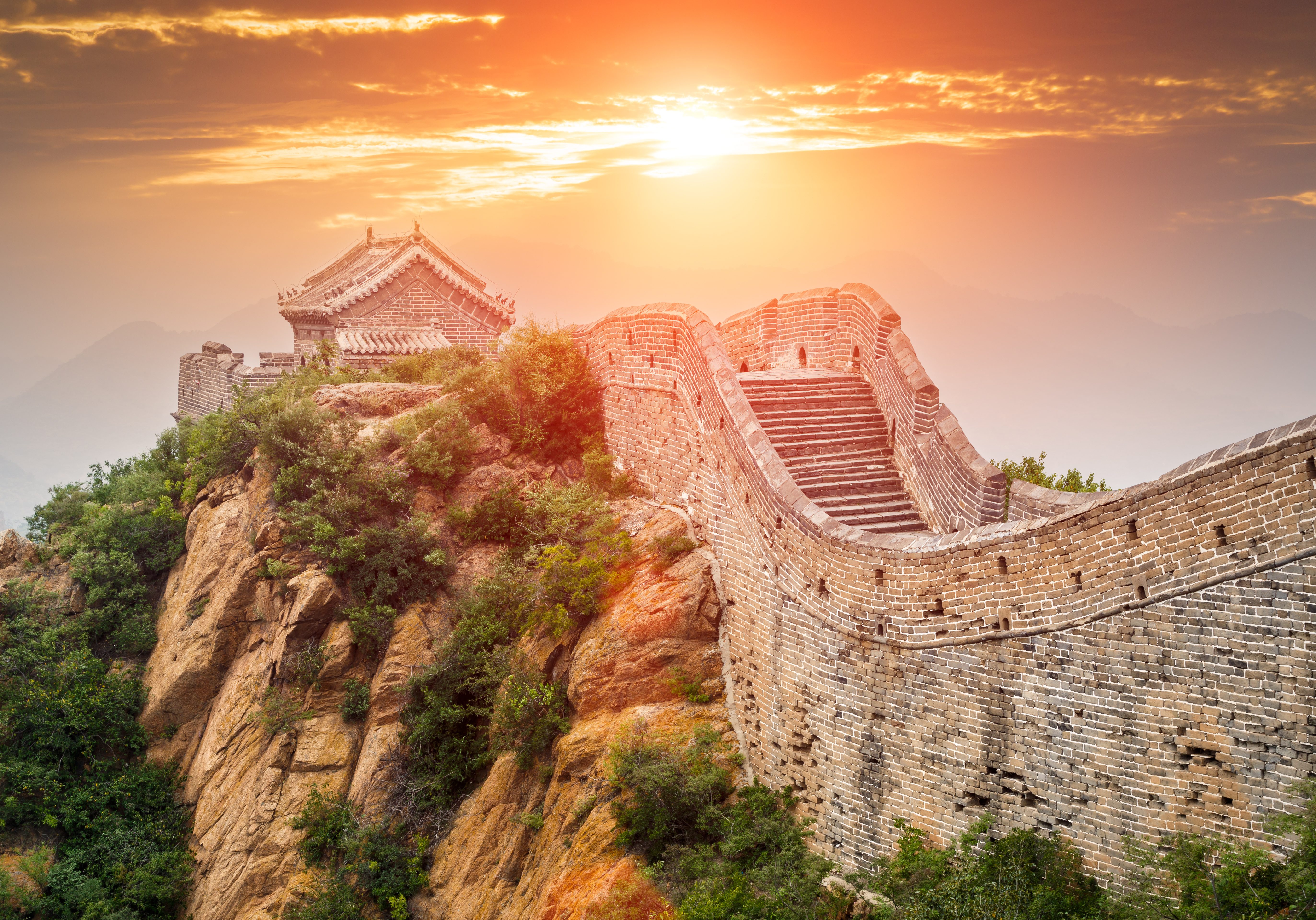 Sun behind the great wall of china