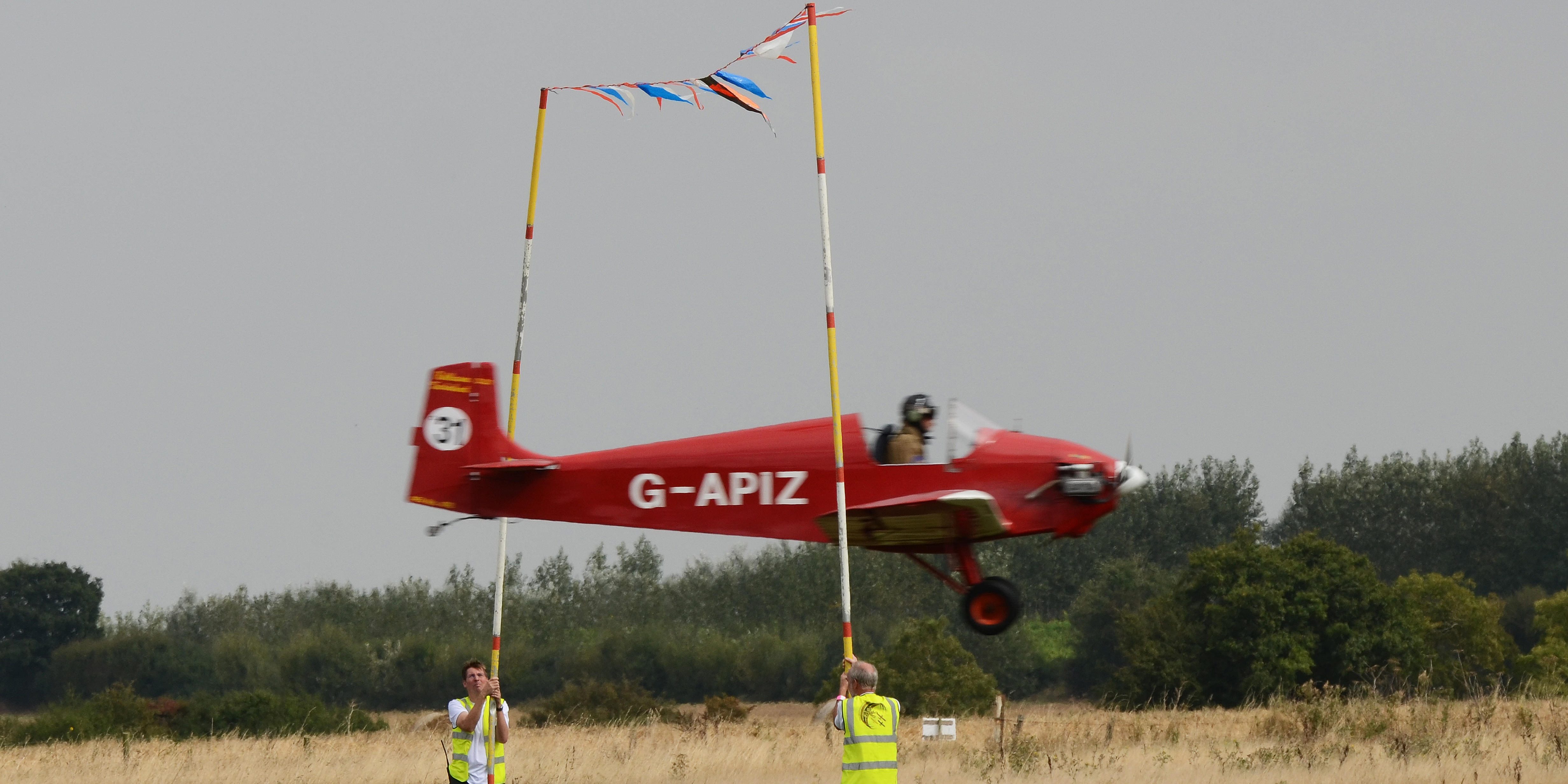 Limbo air display, flying under bunting held up by crew members. 