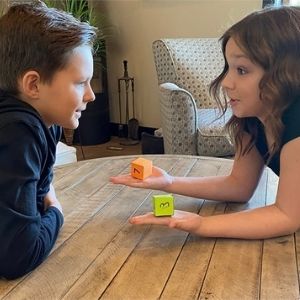 Boy and girl memorizing the multiplication facts with Times Tales cubes.