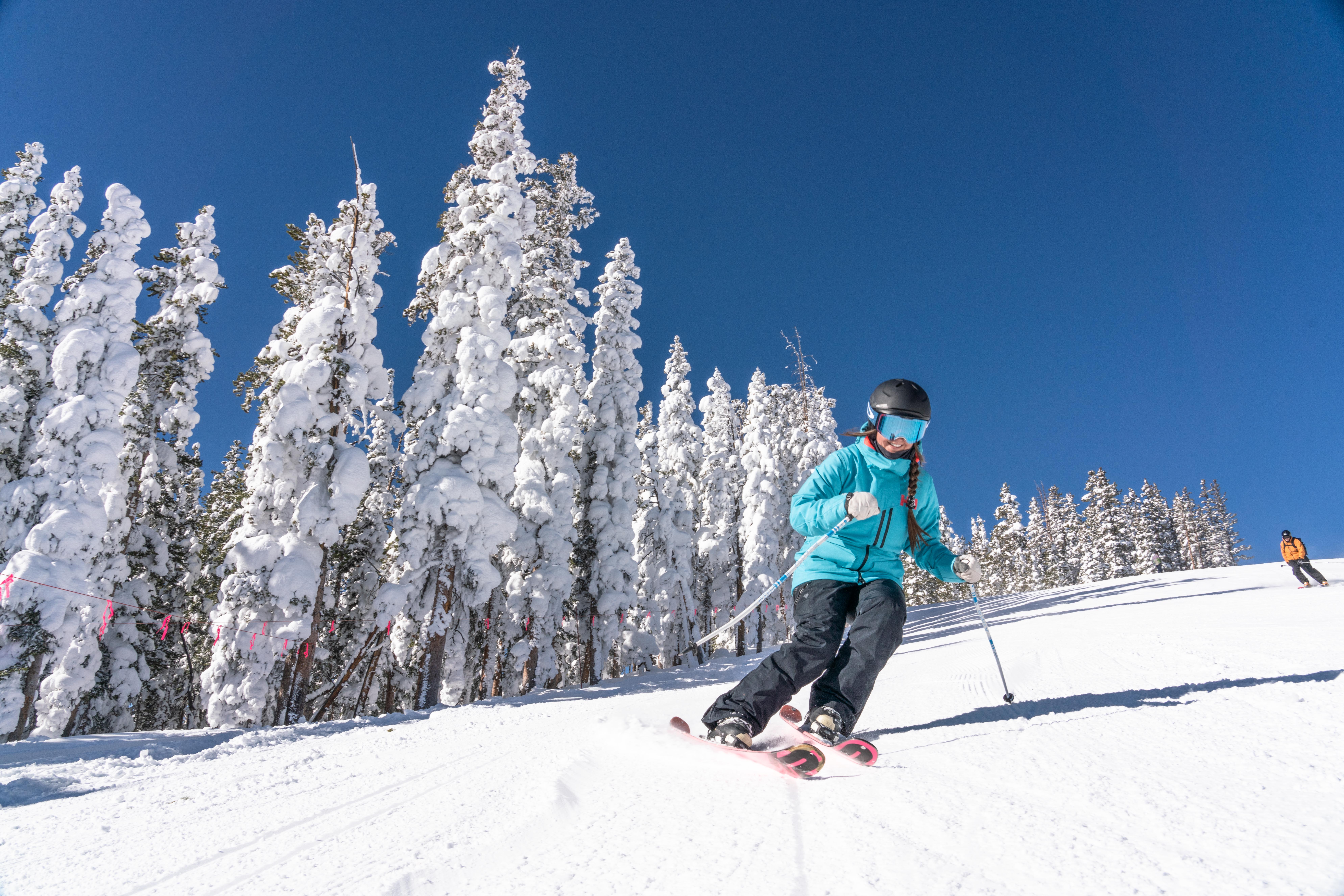 Single female skiier on North Peak on a blue sky day at Keystone